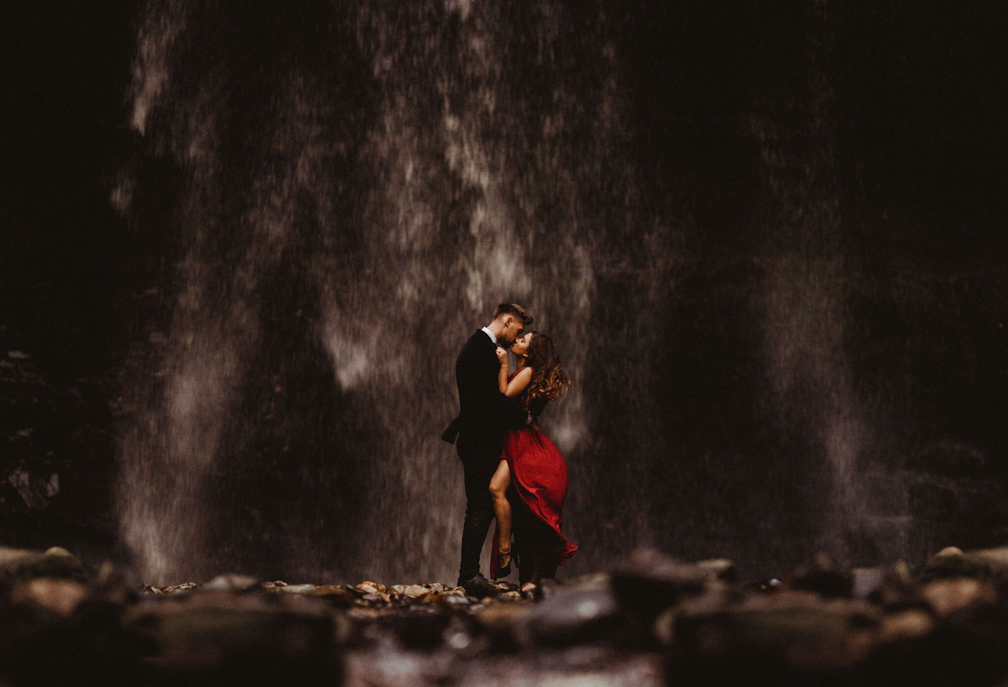 Couple look into each others eyes as a waterfall is behind them | A Las vegas wedding