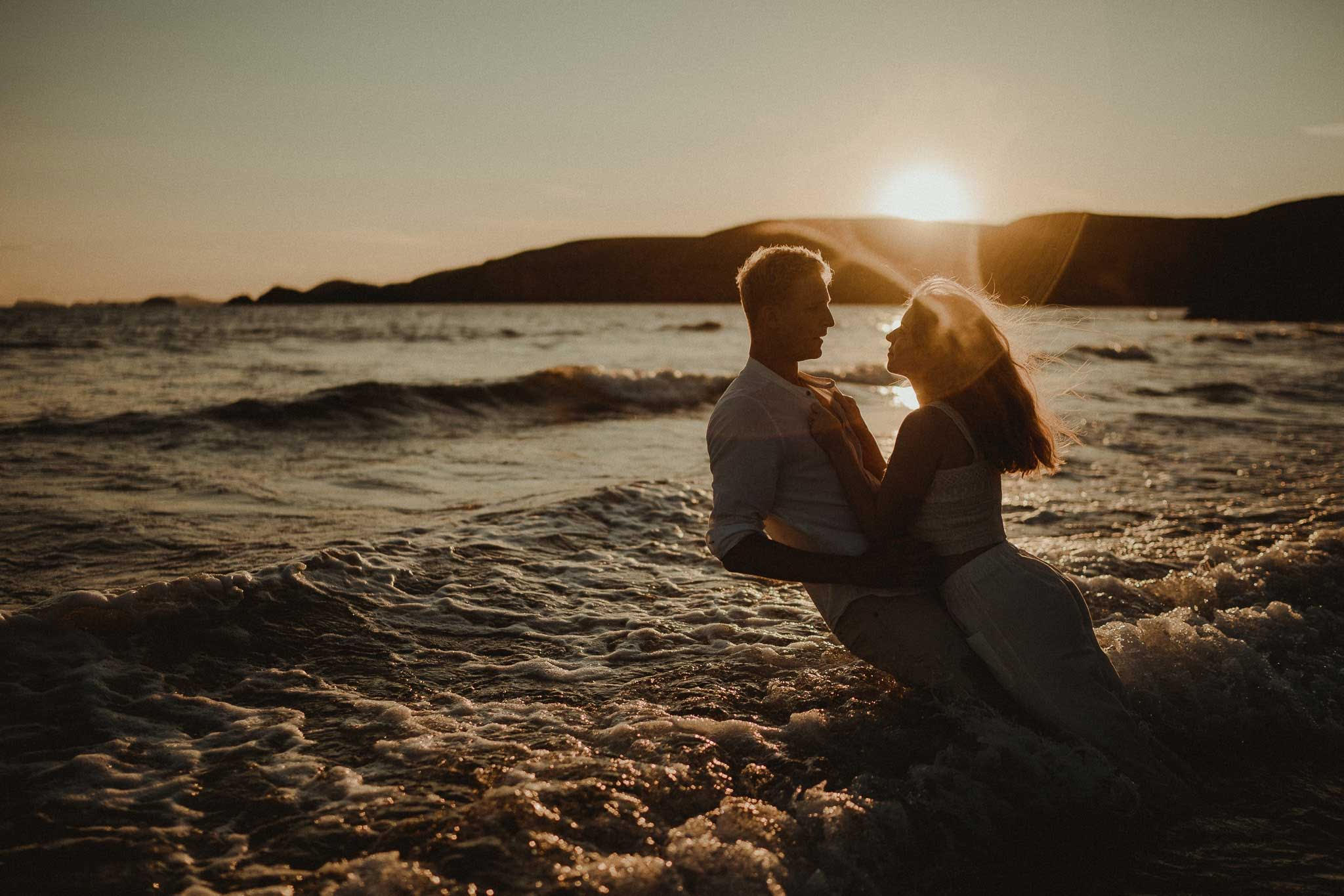 A couple fall back into the sea - engagement session Southerndown