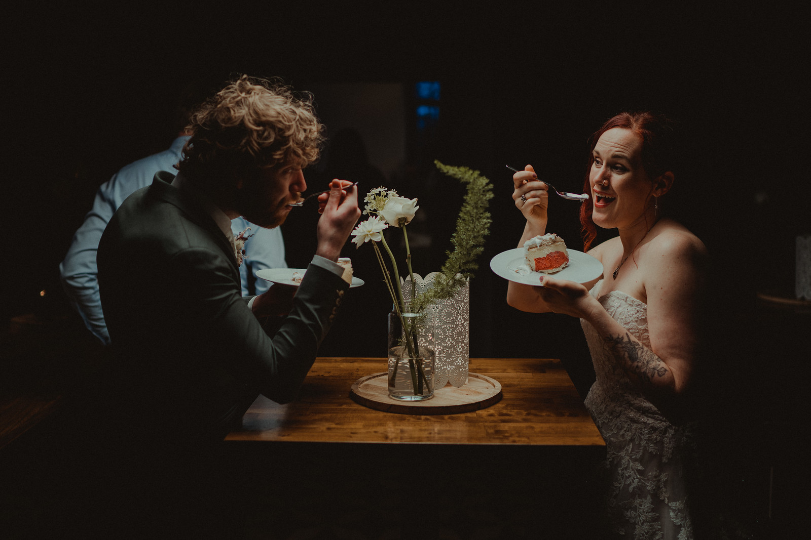 Bride and groom eating cake together
